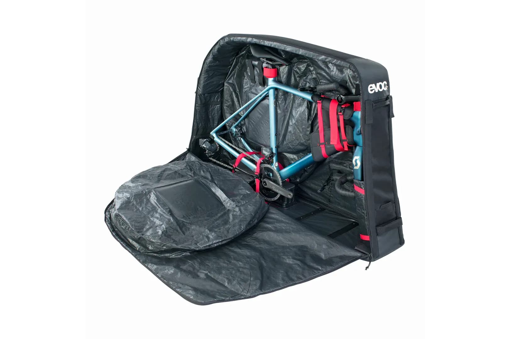 A road bike packed inside an open EVOC bike travel bag, its wheel in a padded pocket beside it