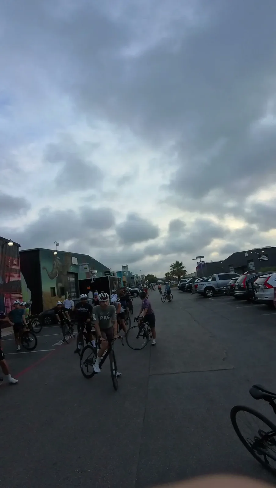 Riders rolling out from the bike shop lot