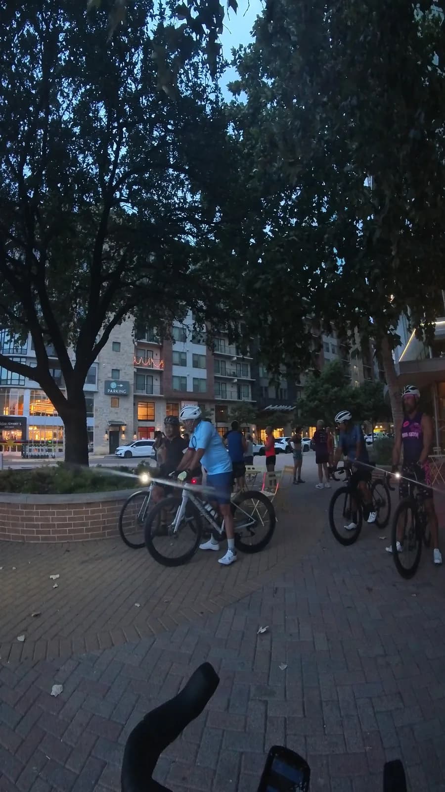 Dusk gathering on the plaza before an evening ride