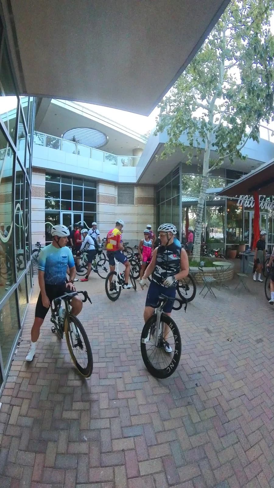 Riders chatting on the brick plaza before a morning ride
