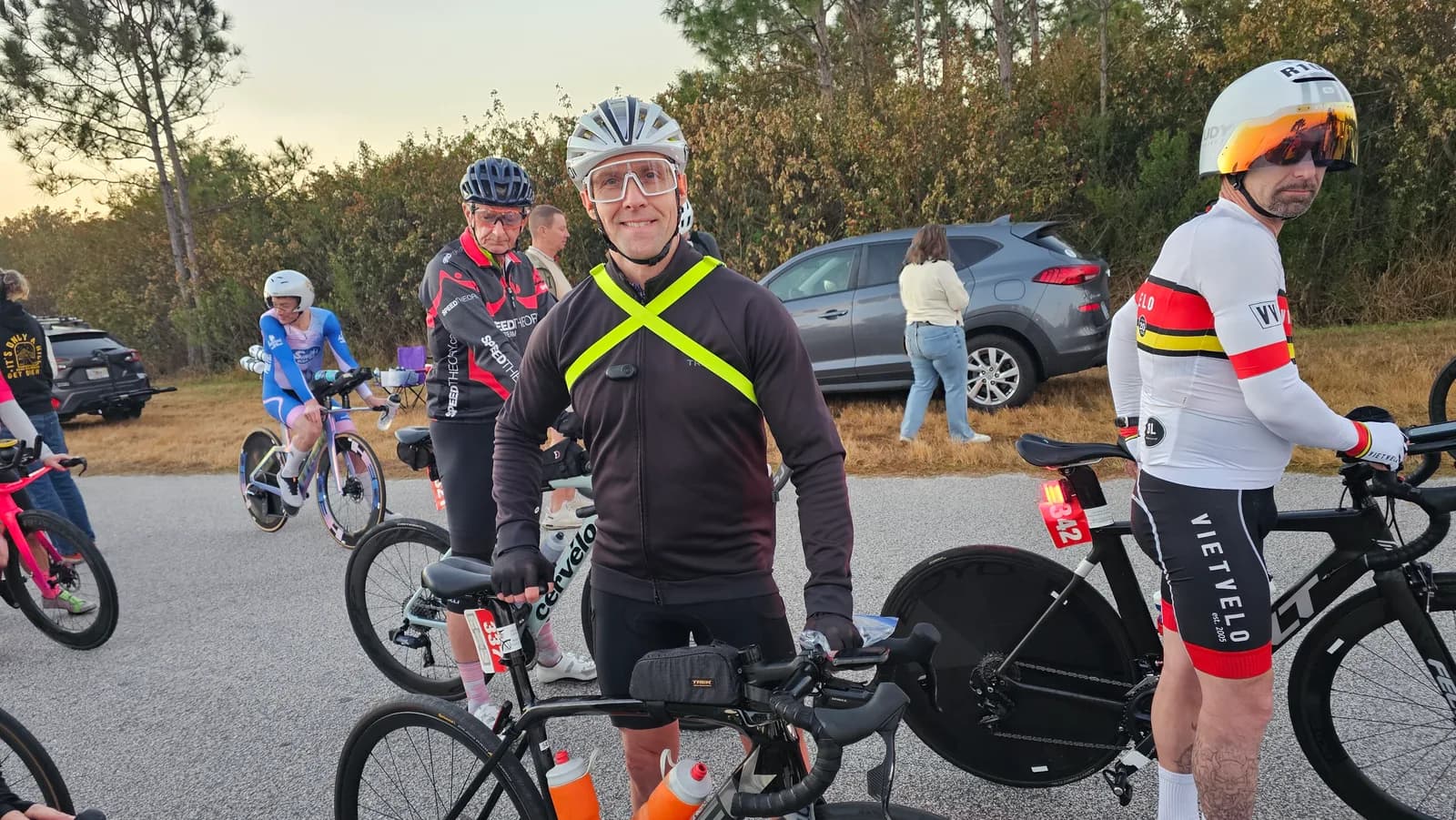 Riders gathering at dawn before an event start, bikes ready