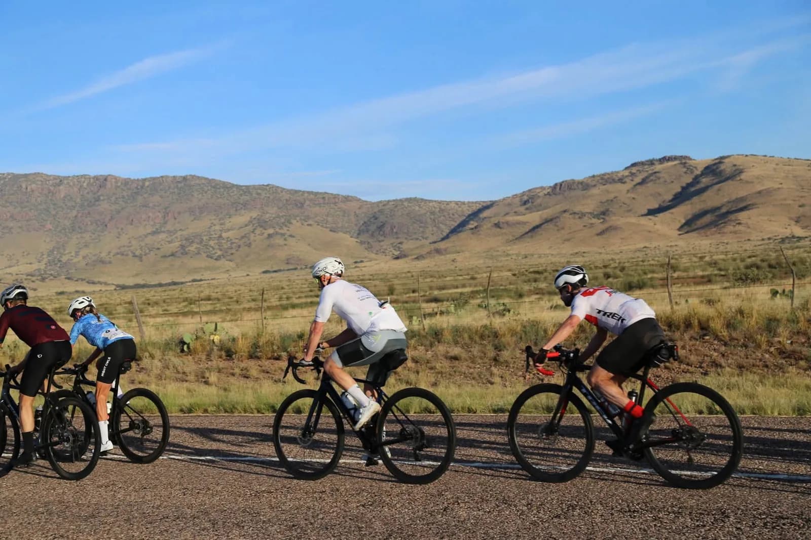 Riders side by side with desert mountains behind