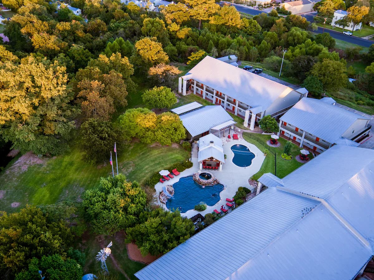 Aerial view of the Fredericksburg Inn & Suites property and the creek behind it