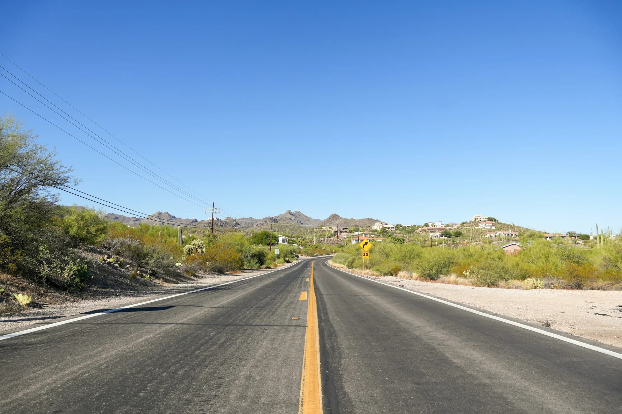 Long straight desert highway through the saguaro flats