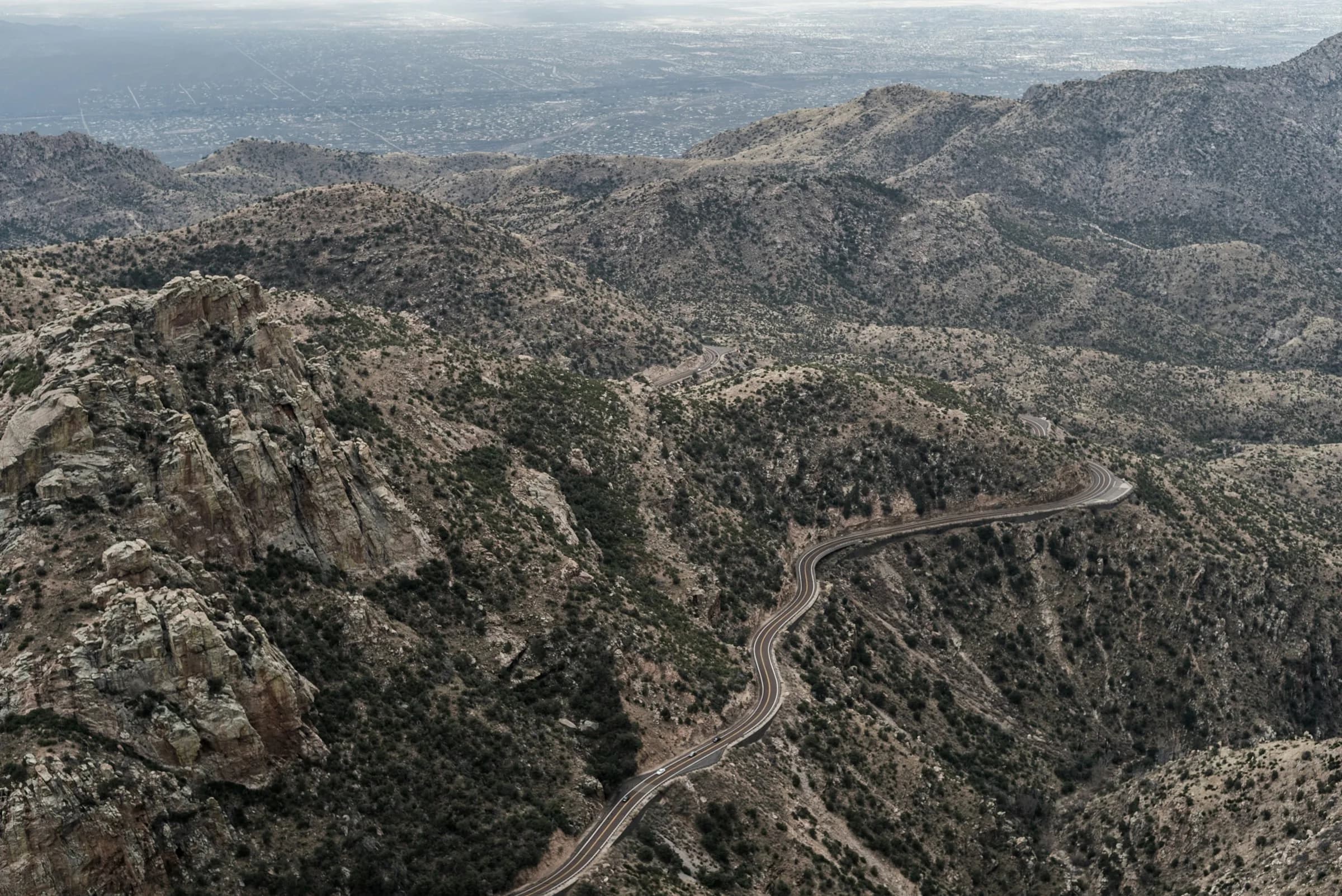 Aerial view of the highway threading toward the mountains